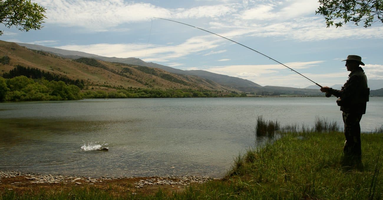 Fishing from the shore of a New Zealand river at dawn