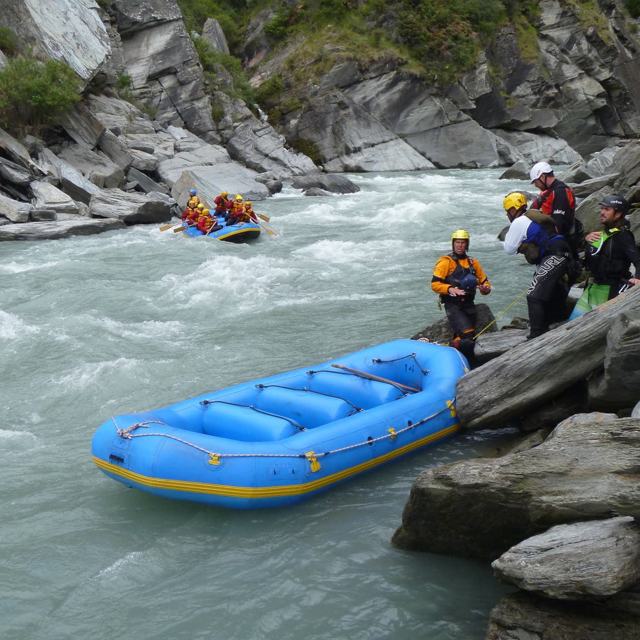 Whitewater rafting team in a New Zealand river gorge
